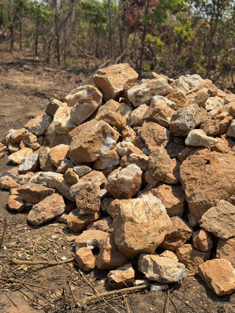 Rock material stockpile in a field area